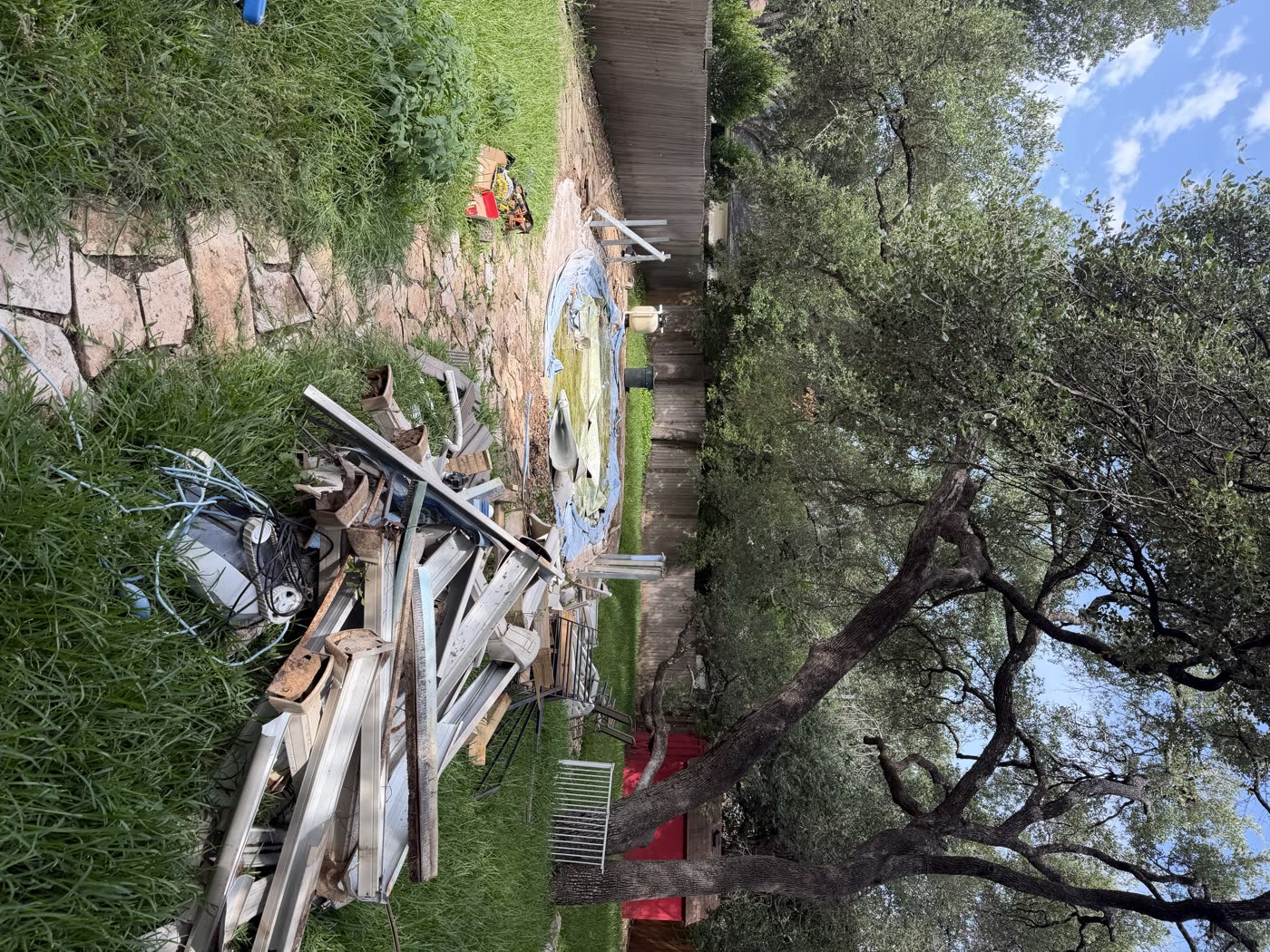 Above-ground pool and deck teardown debris pile